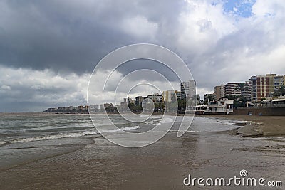 The beach of BenicÃ ssim-BenicÃ¡sim and the Mediterranean Sea joining with rainwater and floods producing a mixture of sediments l Stock Photo